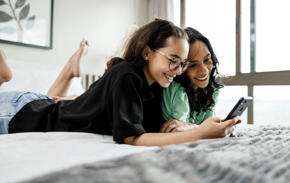 Woman and daughter looking at phone